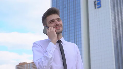 Young successful guy student working on the street on laptop. A man in a white Vídeos de archivo 91419062