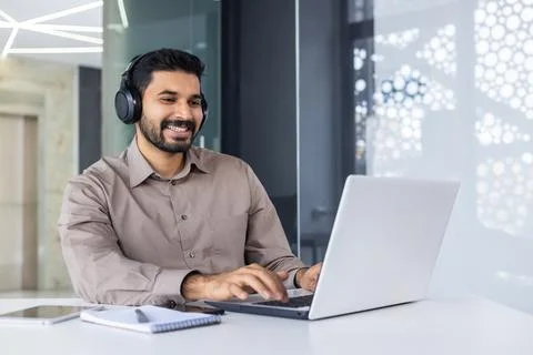Young successful Indian programmer at workplace inside office, man with Stock Photos