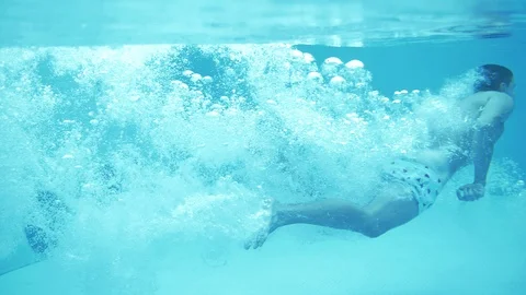 Young successful man dives into the pool water headfirst in slow motion Stock Footage 102652404