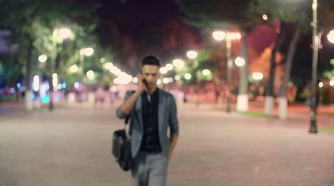 Young successful Manager, walk through the city after work, with coffee in hand Stock Footage