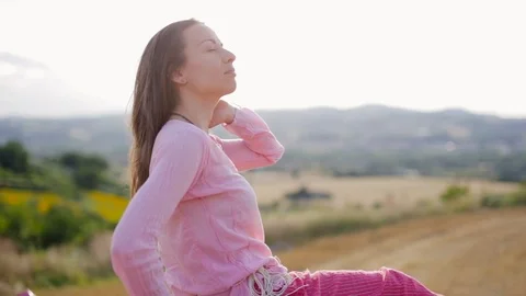 Young at sunset back-light plays with her hair Stock Footage 91964730