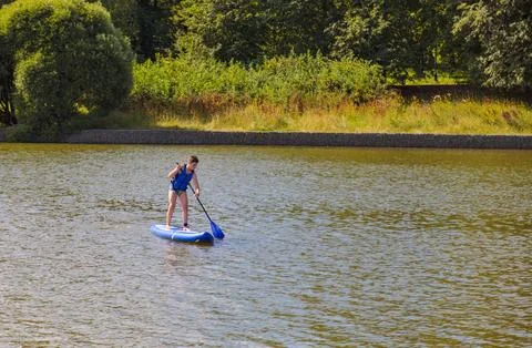 Young SUP Guy Riding the Waves Stock Photos