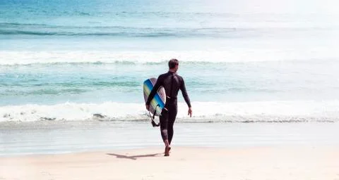 Young surfer on the beach Foto stock