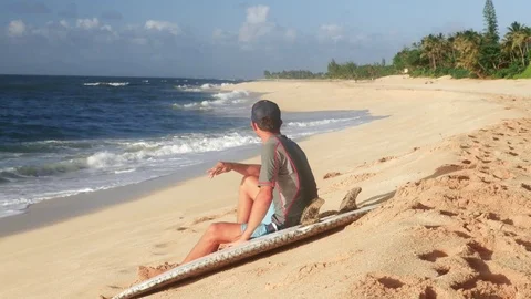 Young surfer on the beach waiting for perfect waves Stock Footage 71837137