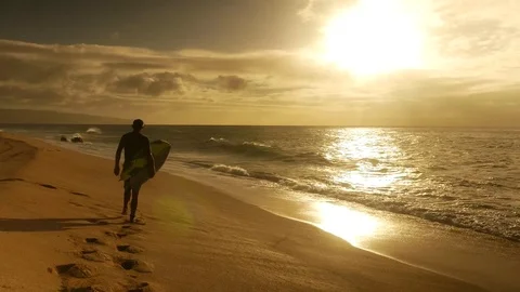 Young surfer on the beach waiting for perfect waves at sunset Stock Footage 71837466