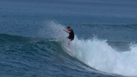 Young surfer on a blue wave Stock Footage 295764386