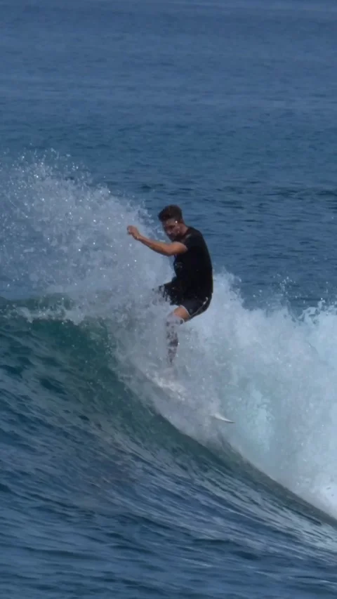 Young surfer on a blue wave Stock Footage 295764449