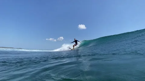 Young surfer in a blue wave Stock Footage 300746797