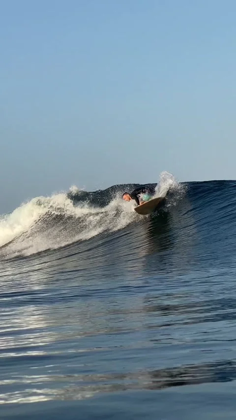 Young surfer on a blue wave. Vertical video Stock Footage 300748214