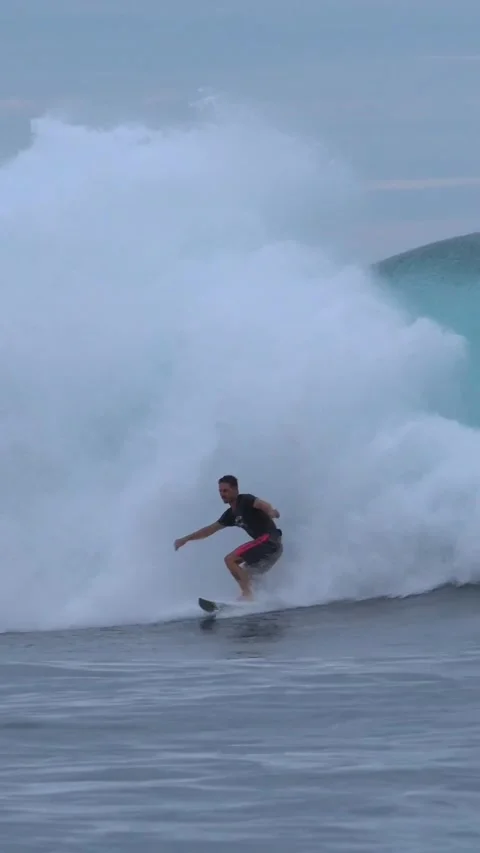 Young surfer on a blue wave.Vertical video Stock Footage 295764183