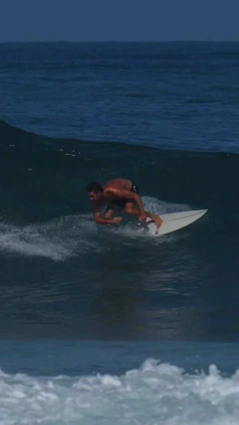 Young surfer on a blue wave.Vertical video Stock Footage 295764240