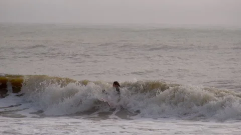 Young surfer falls when tried to ride on waves on a Sunny Day in Jacks Stock Footage 306890300