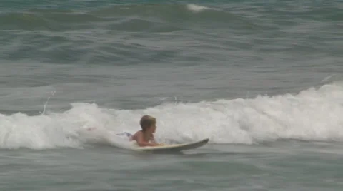 Young surfer rides waves Stock Footage 930944