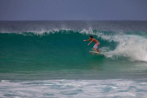 Young surfer riding Stock Photos