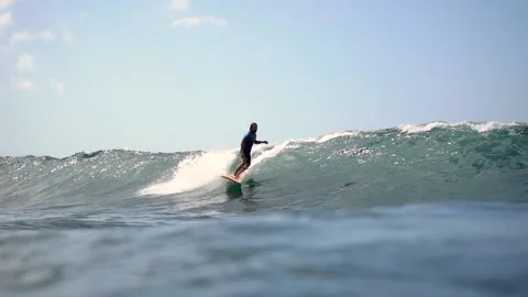 Young surfer riding the waves off the beach coast Bali, Indonesia Vídeos de archivo 136350116