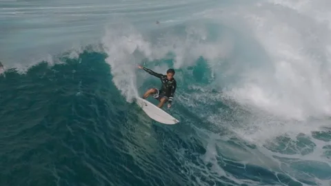 Young surfer surfing big ocean wave slow motion drone shot Stock Footage 264789550