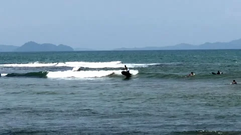 Young  Surfers riding the waves Stock Footage 197070637