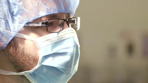 Young Surgeon Looks Down at Operating Table Stock Footage 50941316