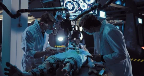 Young surgeon performs an alien operation with the help of equipment and tools Video stock 103869262