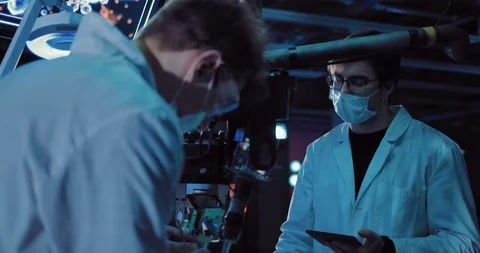 Young surgeons working on an experiment in the laboratory. Devices are connected Stock Footage 103869874
