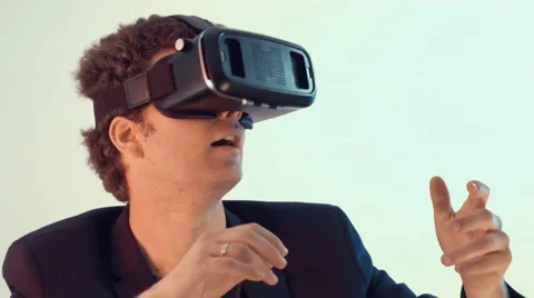 Young surprised man uses virtual reality goggles Stock Footage 63187894