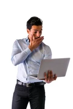 Young surprised man working with computer standing Stock Photos