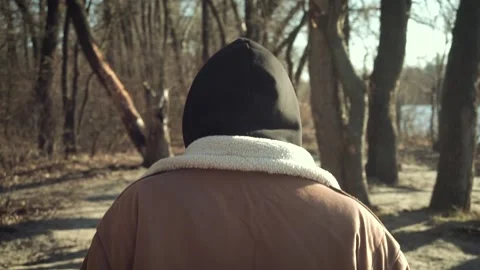 Young suspicious man is chasing a man in the forest. close-up Видео 170442025