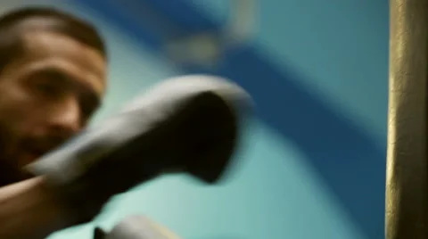 Young sweaty boxer close up pack punches at punching bag 動画素材 64528396