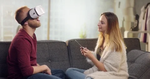 Young sweet couple on couch playing with VR Video stock 78026817