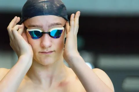 The young swimmer improves goggles. Stock Photos