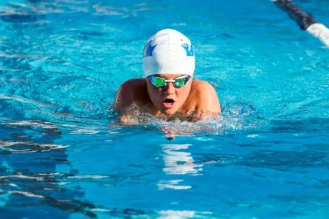 Young swimmer practicing breaststroke. Stock Photos