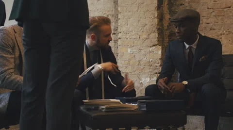 Young Tailor Talking to Young Black Male Customer in Men's Fashion Shop Stock Footage 62554857