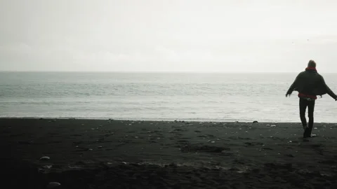Young talanted creative man dancing, singing on Reynisfjara Beach, Iceland Video stock 253690732