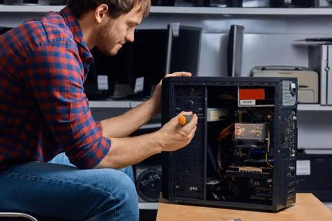 Young talented man gathering the system unit Stock Photos