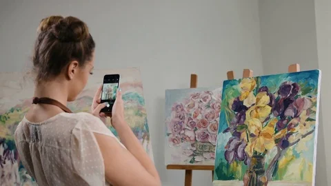 Young talented painter finished to draw her new masterpiece and taking pictures Stock Footage 74211030