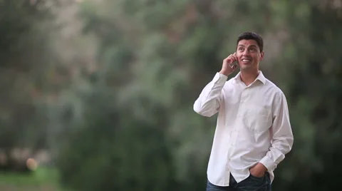 Young talking on phone in the nature Stock Footage 56809965