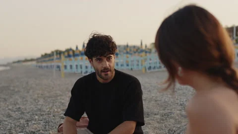 Young talking on the sea shore Stock Footage 170825732