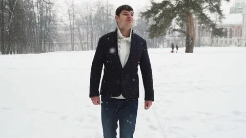 Young tall man walking during snowstorm Stock Footage 72736967