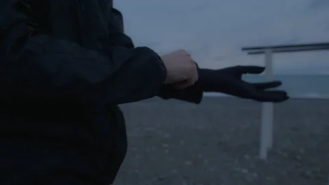 Young tall person is dressing up. Training on open air at nasty weather Stock Footage 147920703