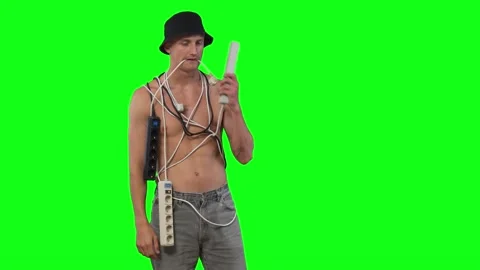 Young tangled in wires puts an extension cord to his ear and rings funny 動画素材 239666334