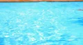 Young Tanned Man Swimming the Crawl in a Pool. Sunny Summer Day. HD Footage