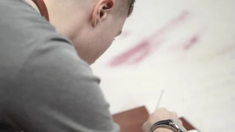 Young tanner in the workshop working on the product. Production by hands of a Stock Footage 104926661