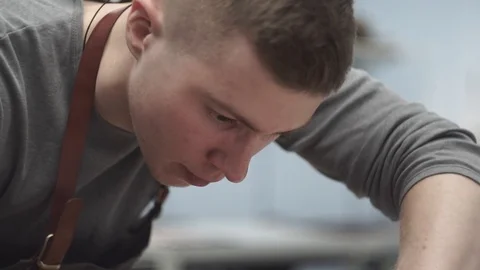 Young tanner in the workshop working on the product. Production by hands of a Stock Footage 104926740