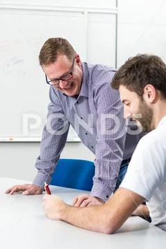 Young teacher explaining english grammar. Study english. Stock Photos