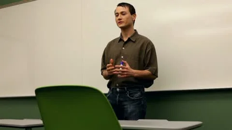 Young teacher in front of white board Stock Footage 10699486