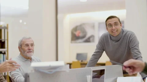 Young teacher having class with senior people in library Stock-Footage 232621751