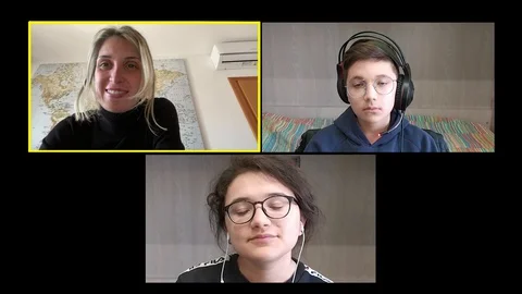 Young teacher lecturing her two students by zoom Stock Footage 127828218