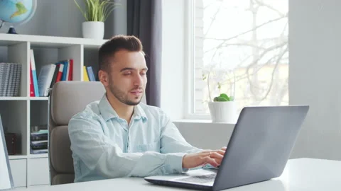 Young Teacher makes an Online Lesson while Sitting in Front of Computer at Home Stock Footage 200906403