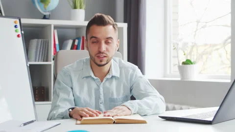 Young Teacher makes an Online Lesson while Sitting in Front of Computer at Home Stock Footage 201147653