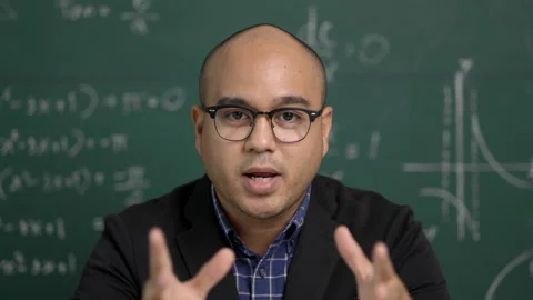 Young teacher man looking at camera sitting teaching online video conference liv Stock-Footage 153504936